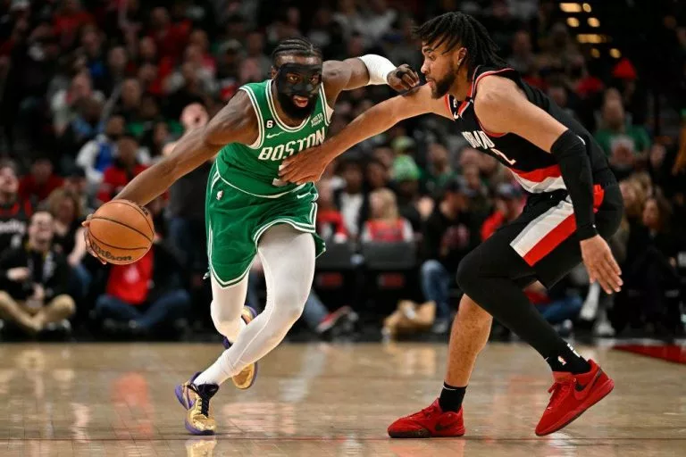 Jaylen Brown #7 of the Boston Celtics drives against Trendon Watford #2 of the Portland Trail Blazers